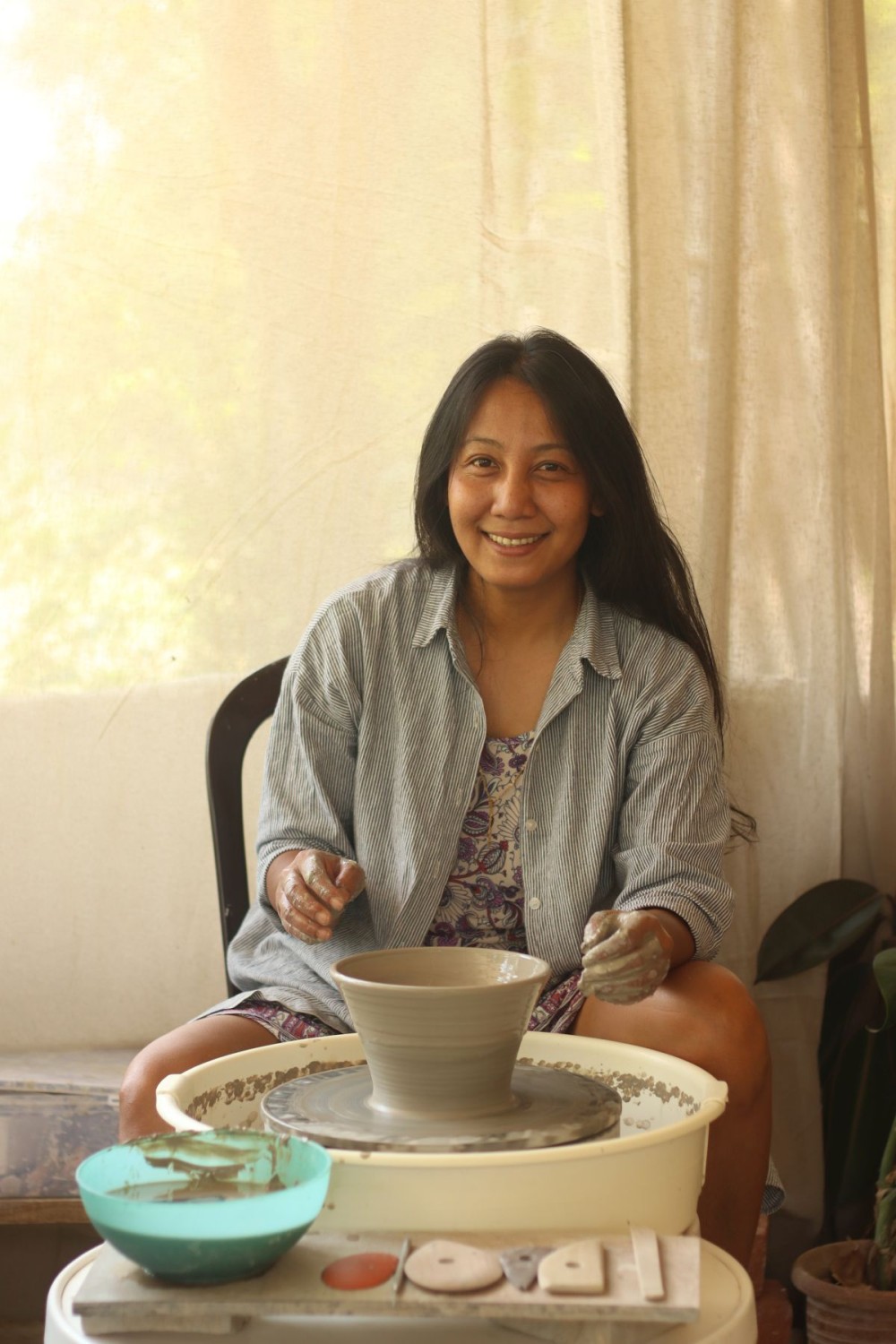 Ceramicist Lipoklemla Ao at work, shaping art from clay.